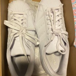 All white Adidas Superstars